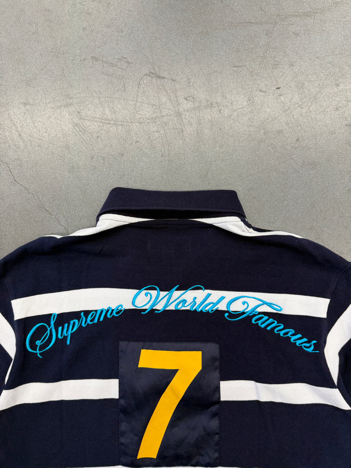 SS25 SUPREME CURSIVE POLO SHIRT - NAVY STRIPE