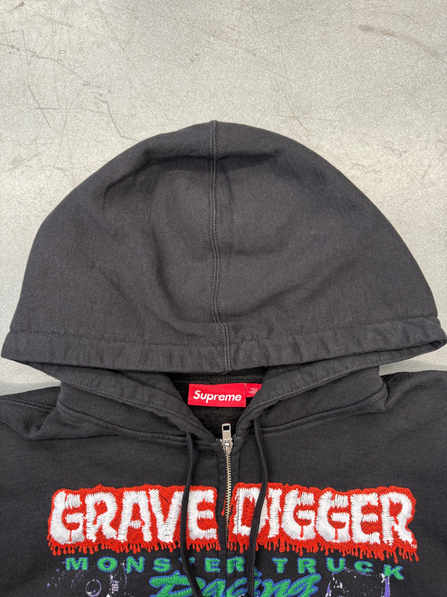 SS26 SUPREME MONSTER JAM GRAVE DIGGER GREEN/PURPLE ZIP UP HOODED SWEATSHIRT