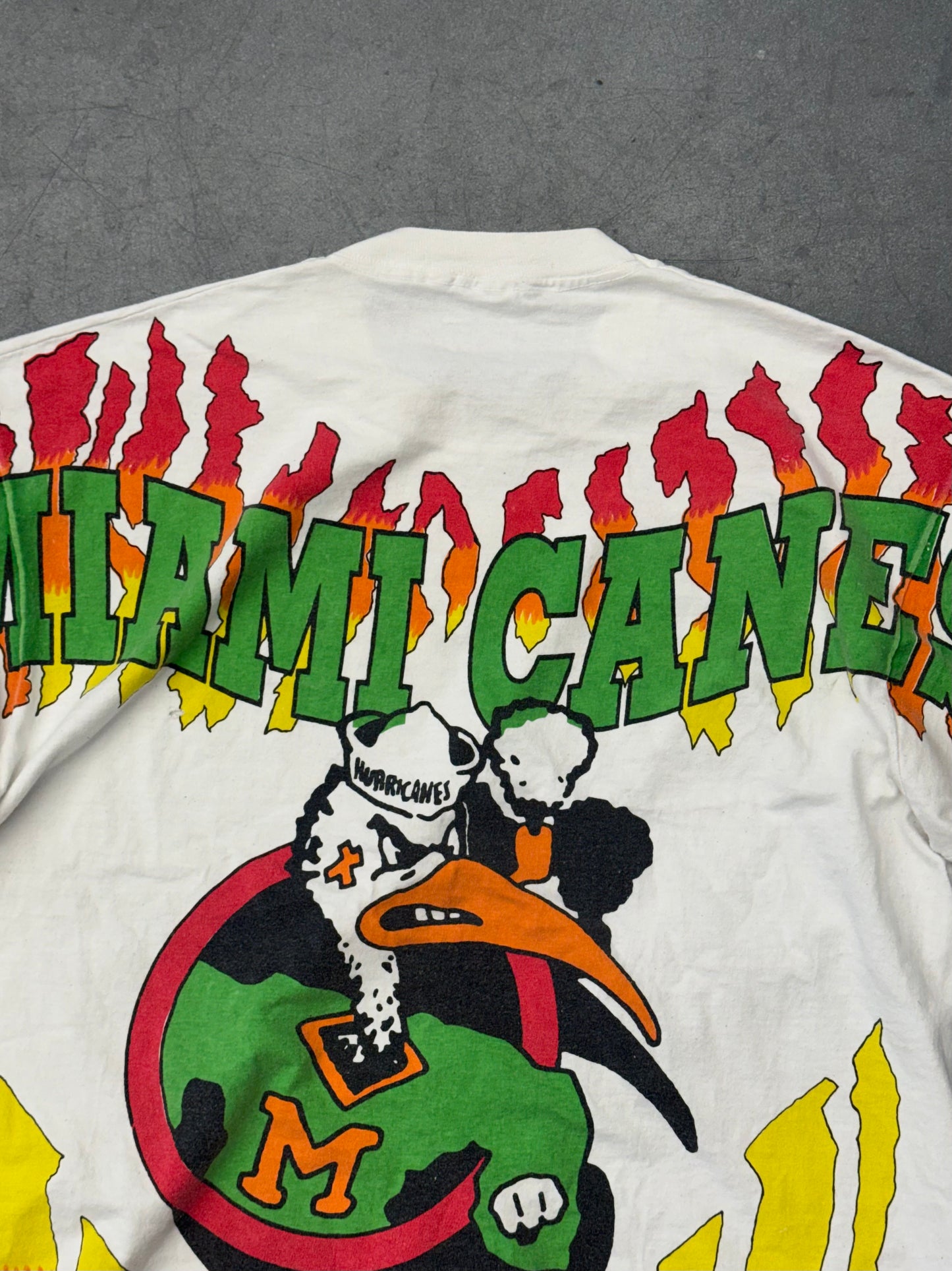 90S UNIVERSITY OF MIAMI SEBASTIAN CIRCLE LOGO FLAMES AOP TEE (FOTL TAG)