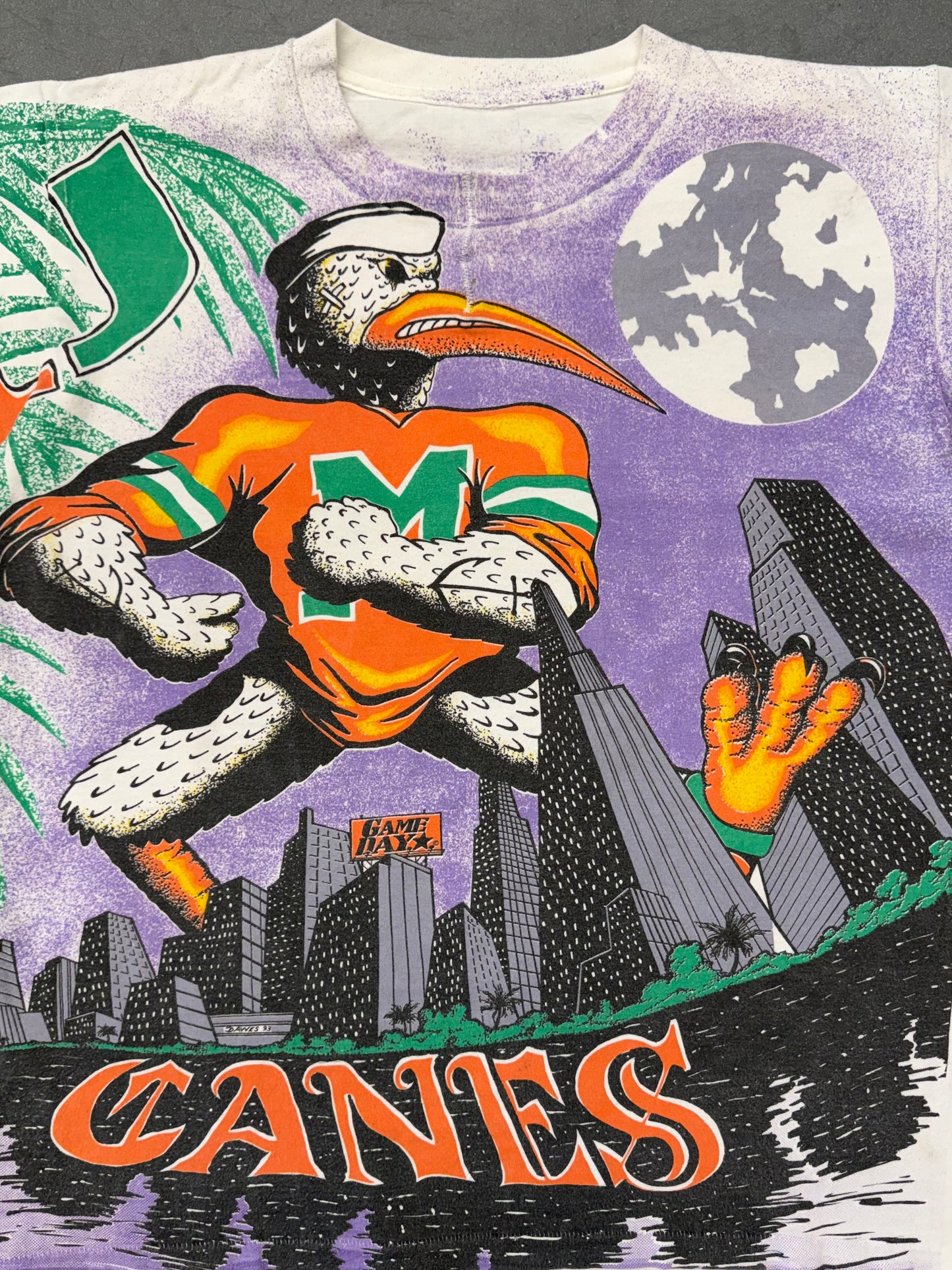 90'S UNIVERSITY OF MIAMI CANES PURPLE CITY SKYLINE GAME DAY AOP TEE (PULLED TAG) (REPAIRED NECK)