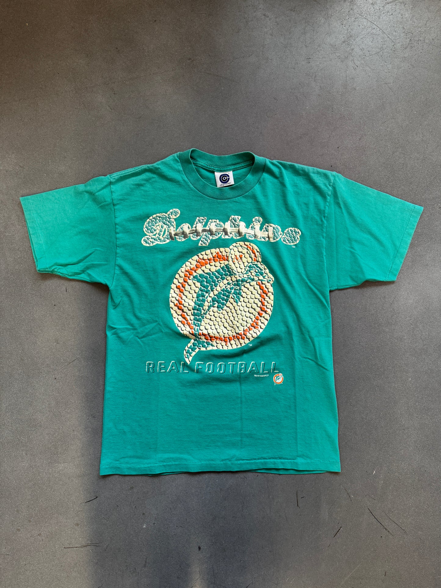 1996 MIAMI DOLPHINS FOOTBALL TEXTURE AND LACE PRINT LOGO "REAL FOOTBALL" TEE (COLLEGE CONCEPTS TAG)