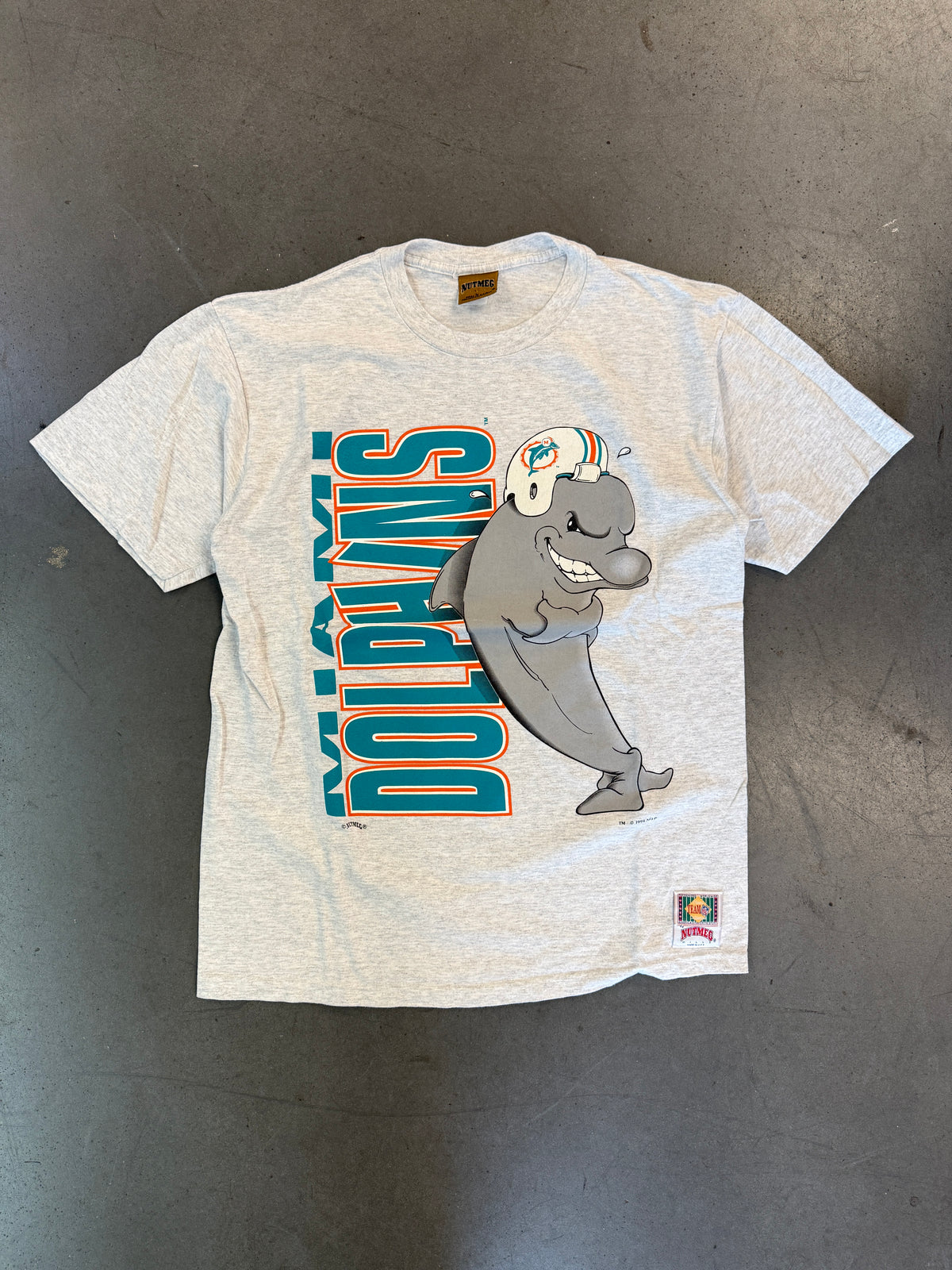 1994 MIAMI DOLPHINS VERTICAL SPELL-OUT ANIMATED DOLPHIN TEE (NUTMEG TAG)