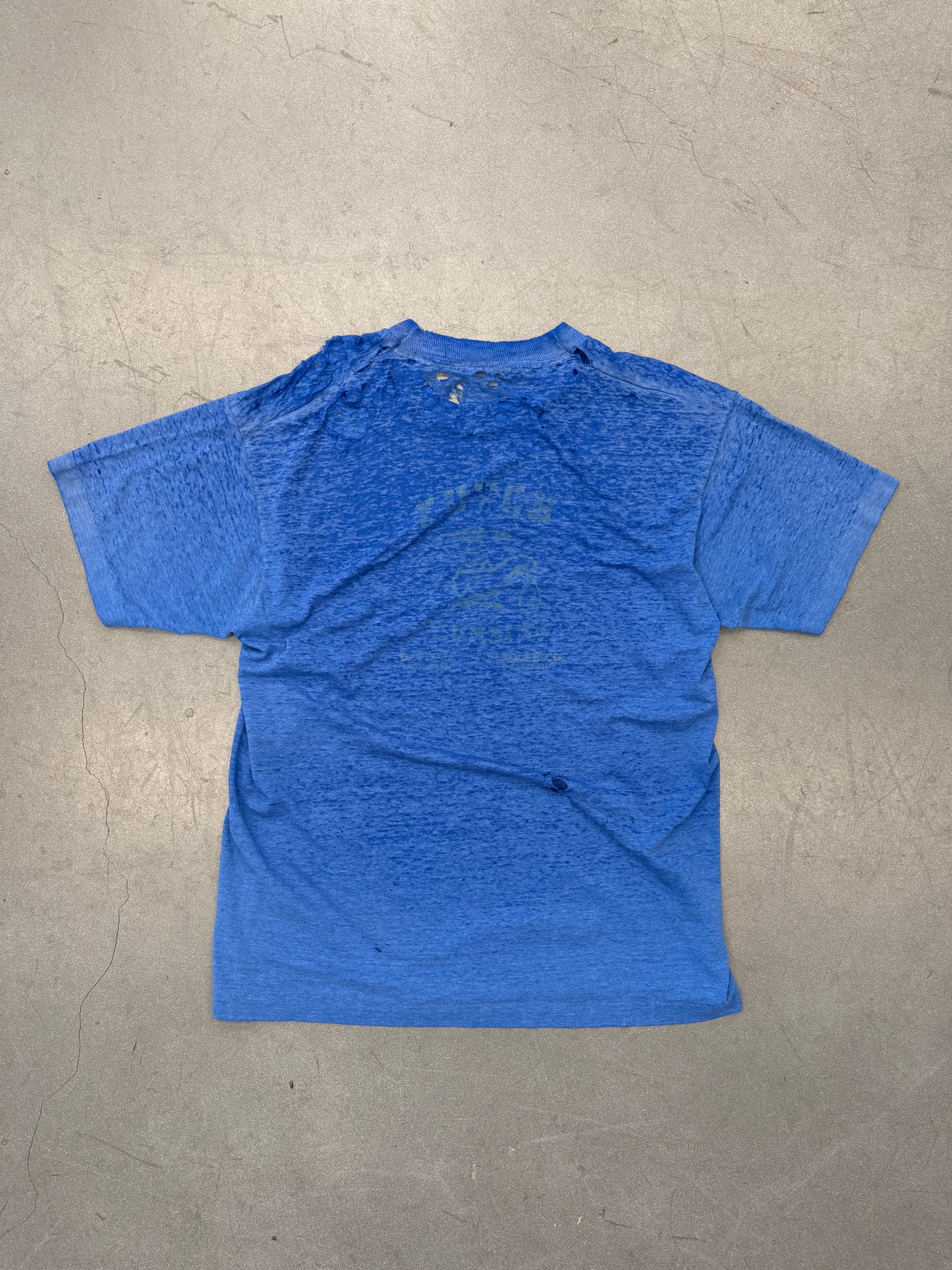 VINTAGE THRASHED THIN BLUE TEE WITH YELLOW LETTERS ON BACK (PULLED TAG)