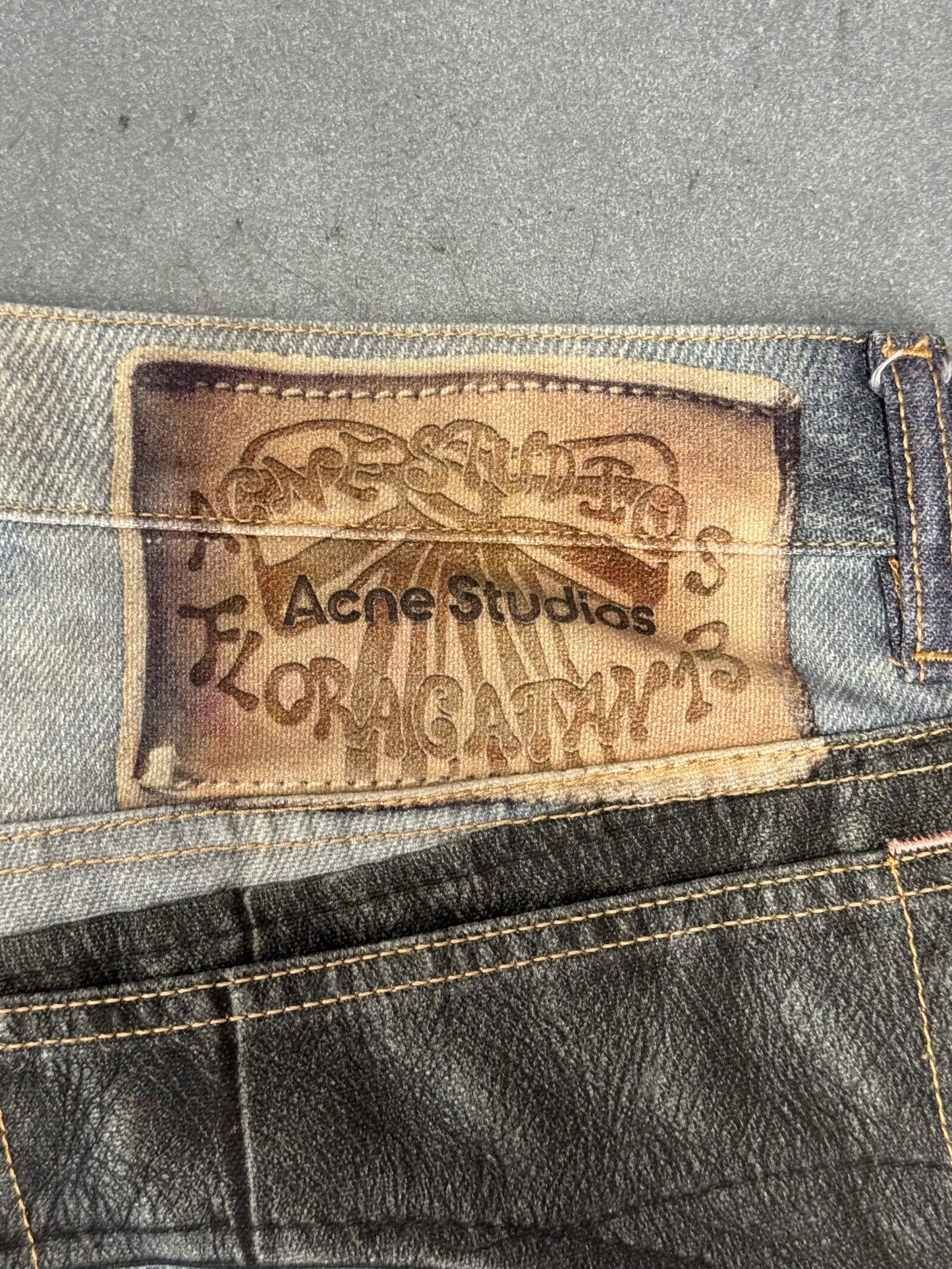 ACNE STUDIOS LEATHER CHAPS PRINTED JEANS