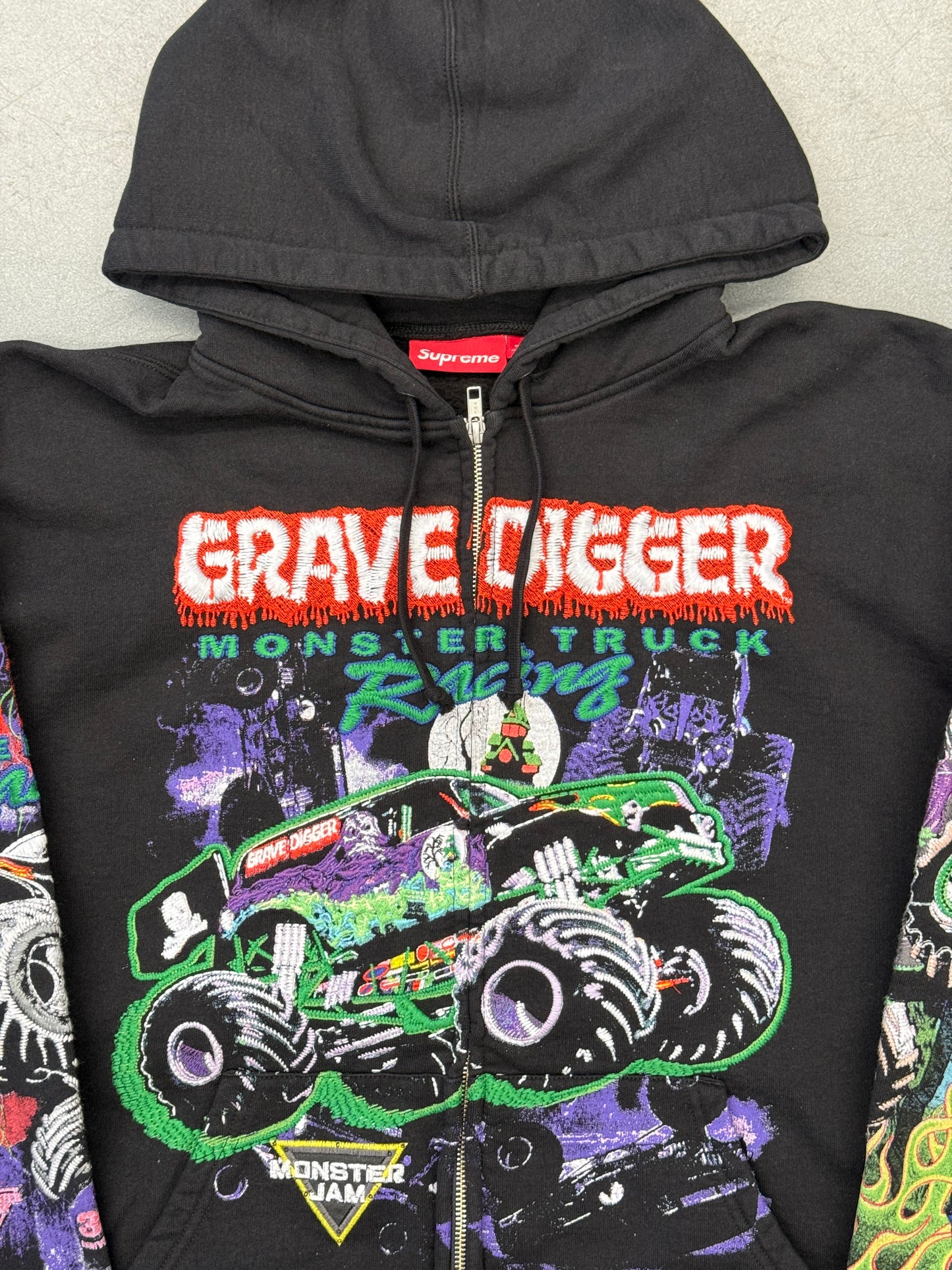 SS26 SUPREME MONSTER JAM GRAVE DIGGER GREEN/PURPLE ZIP UP HOODED SWEATSHIRT