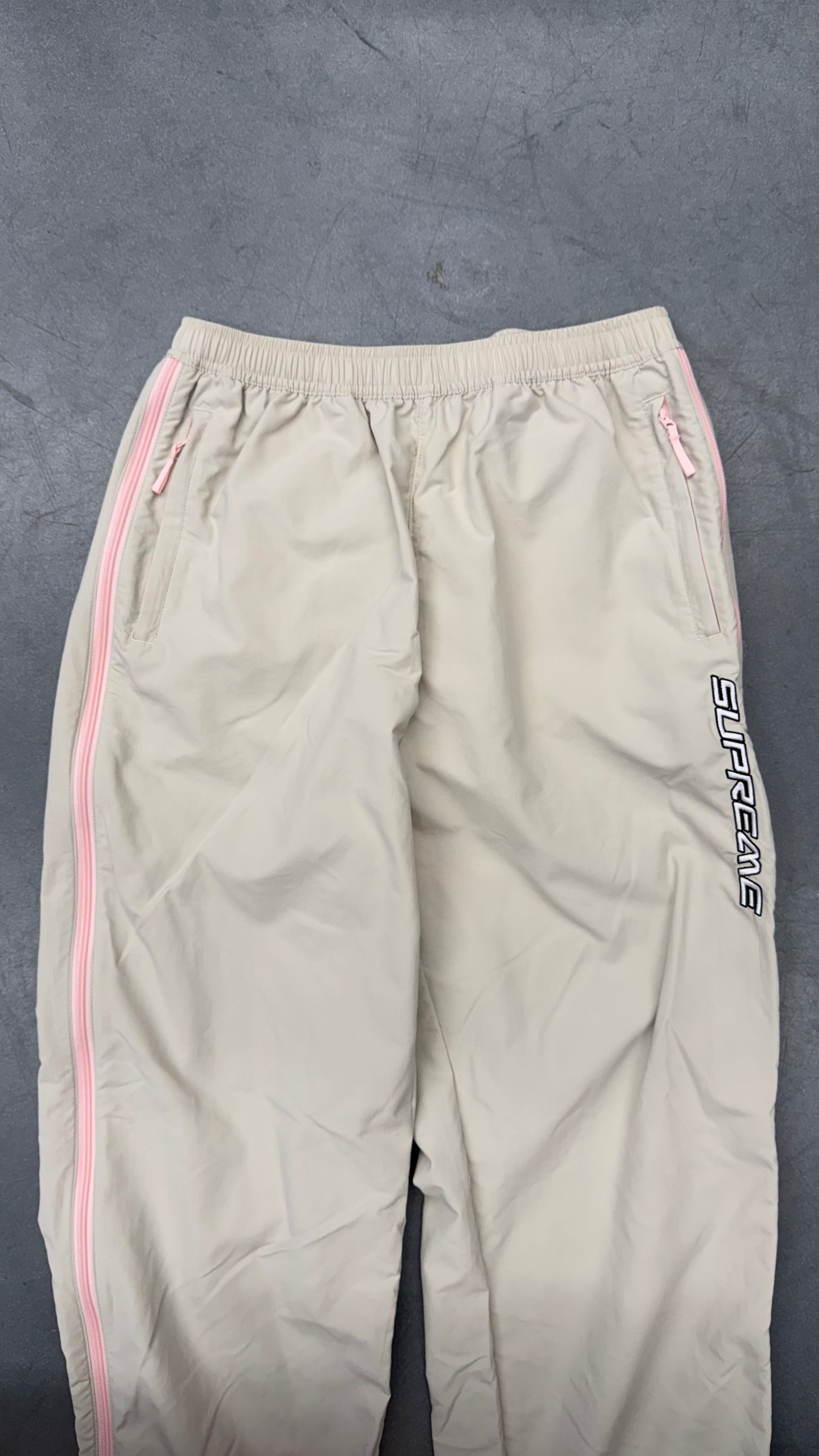 SS25 SUPREME CONTRAST ZIP WARM UP PANT - STONE/PINK