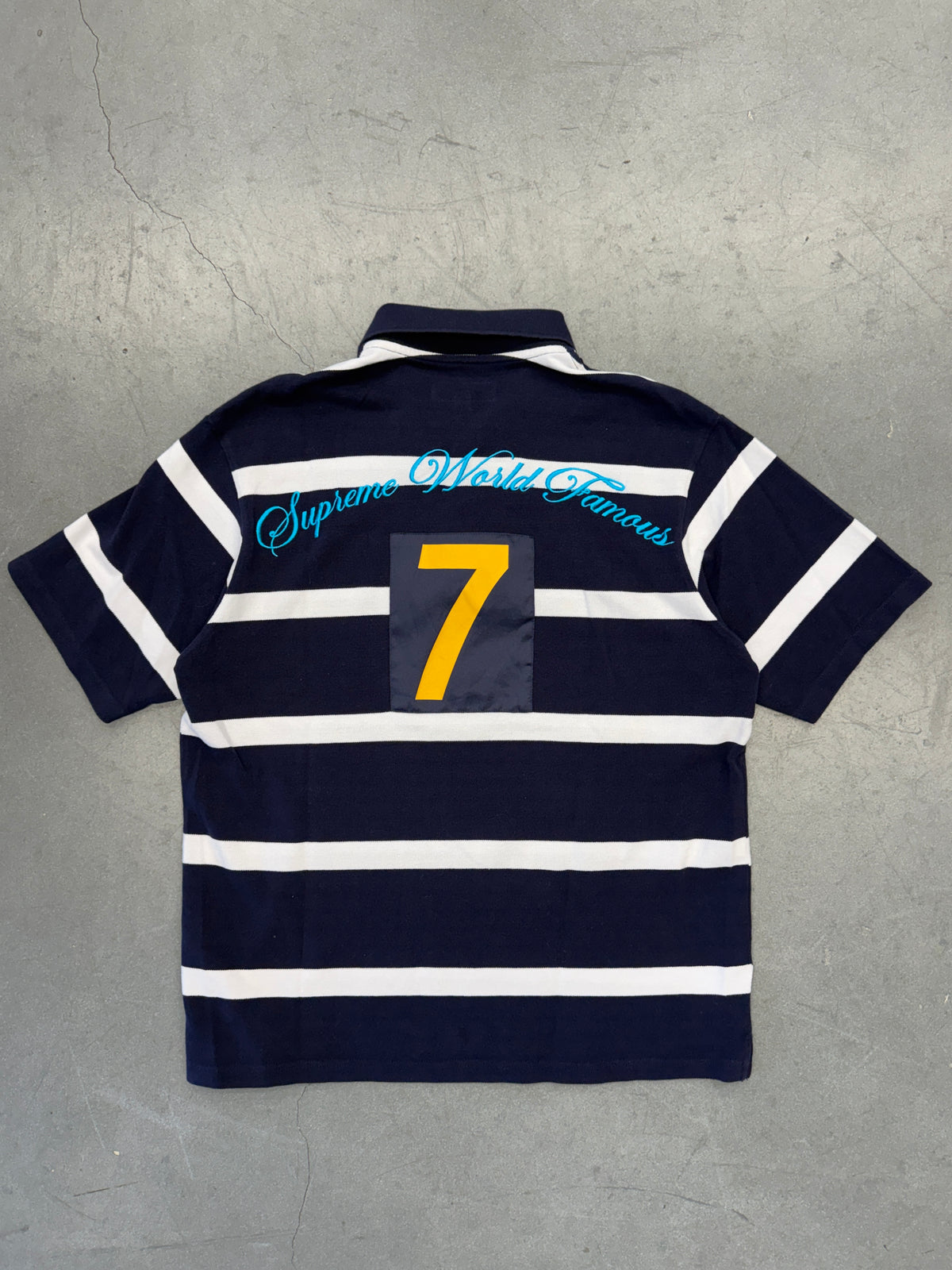 SS25 SUPREME CURSIVE POLO SHIRT - NAVY STRIPE