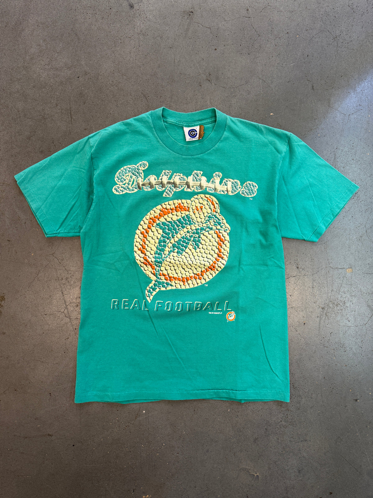 1996 MIAMI DOLPHINS FOOTBALL TEXTURE AND LACE PRINT LOGO "REAL FOOTBALL" TEE (COLLEGE CONCEPTS TAG)