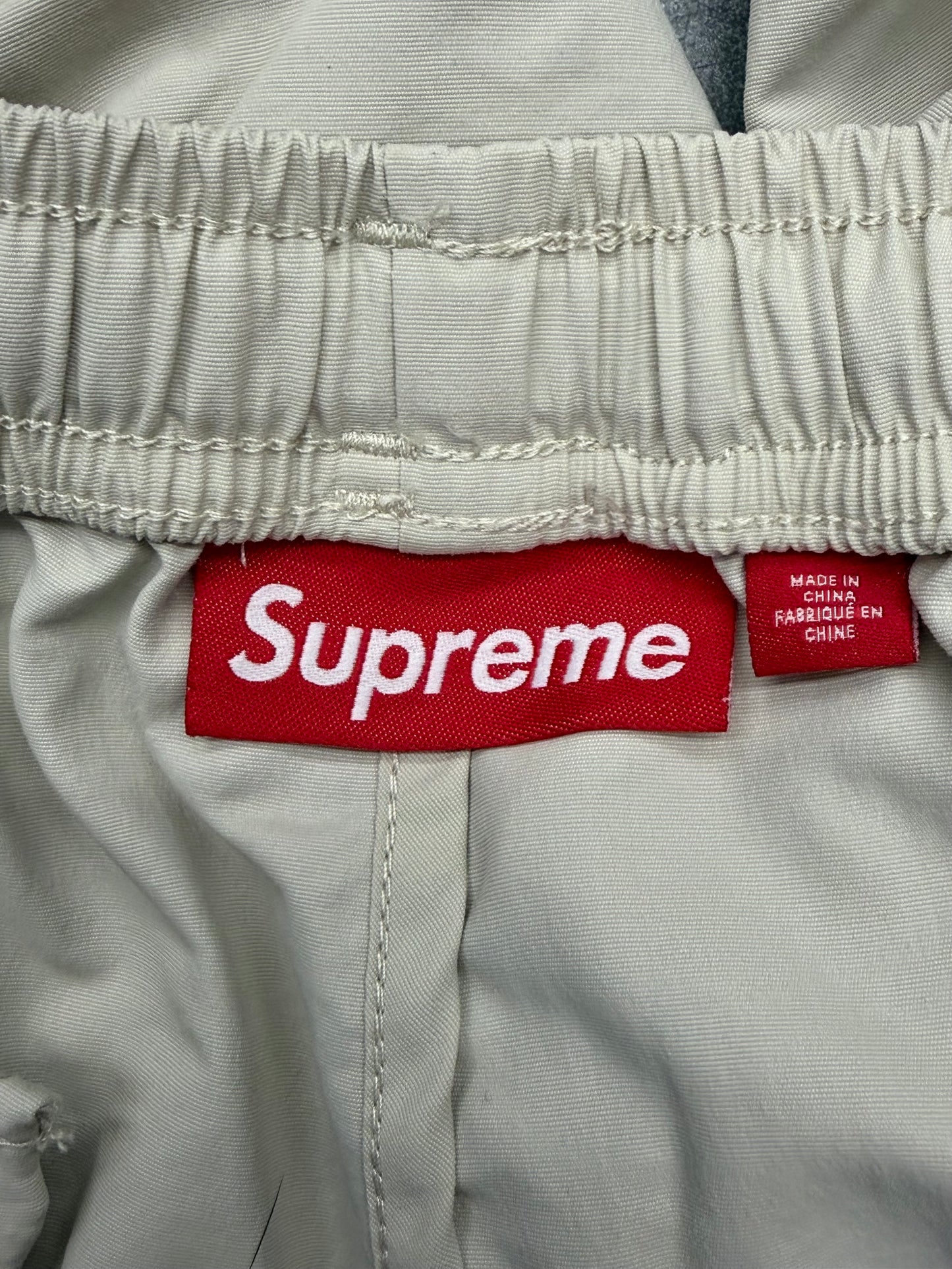 SS25 SUPREME CONTRAST ZIP WARM UP PANT - STONE/PINK