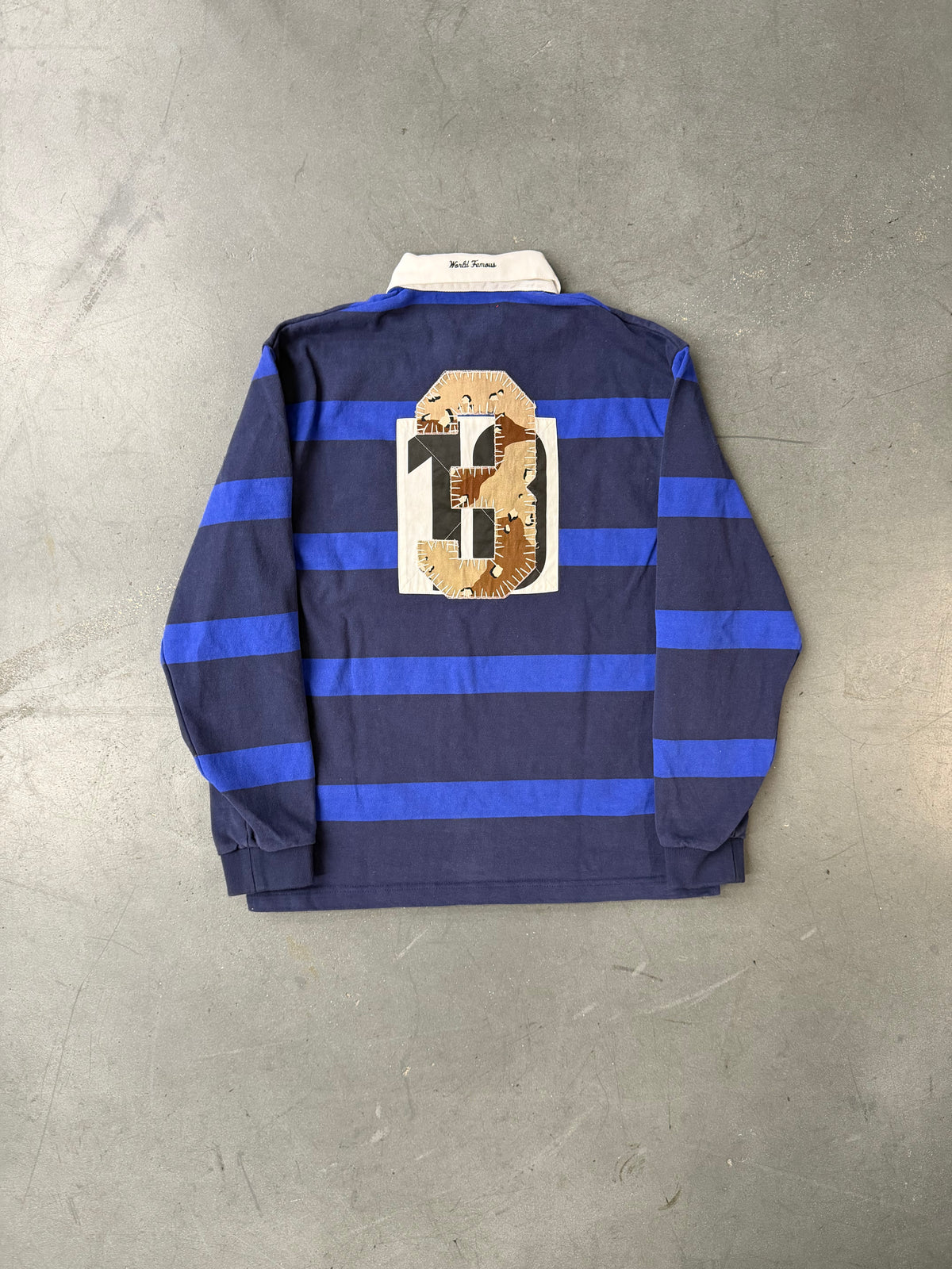 FW25 SUPREME STRIPE RUGBY SHIRT - NAVY