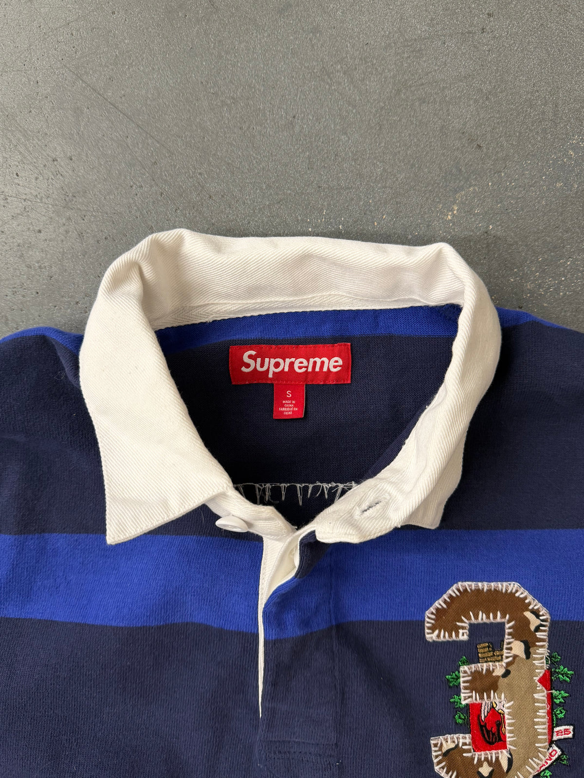 FW25 SUPREME STRIPE RUGBY SHIRT - NAVY