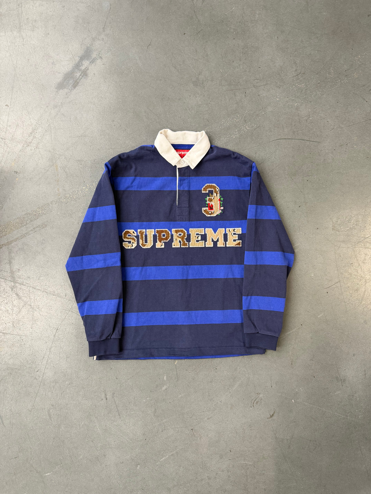 FW25 SUPREME STRIPE RUGBY SHIRT - NAVY
