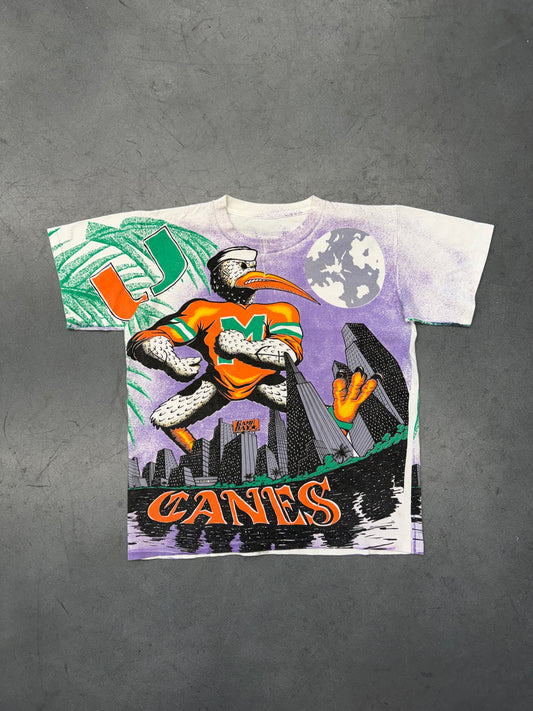 90'S UNIVERSITY OF MIAMI CANES PURPLE CITY SKYLINE GAME DAY AOP TEE (PULLED TAG) (REPAIRED NECK)