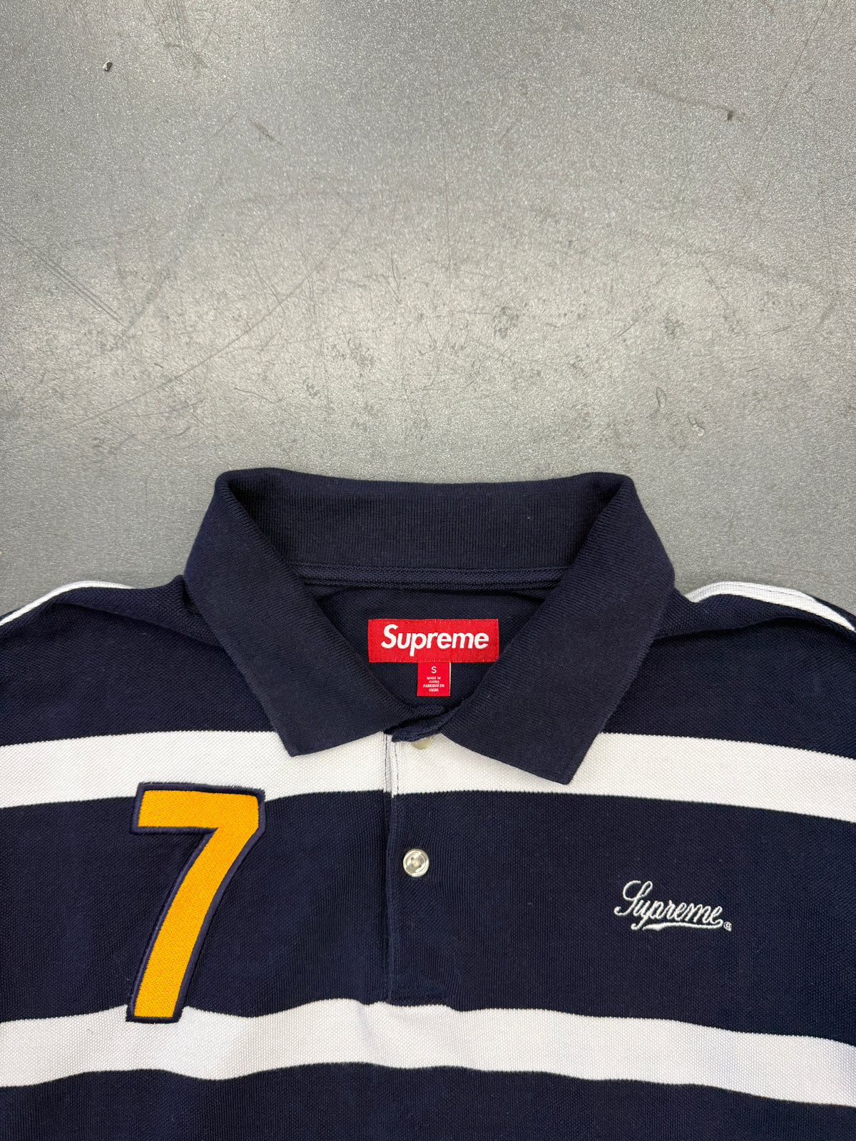 SS25 SUPREME CURSIVE POLO SHIRT - NAVY STRIPE