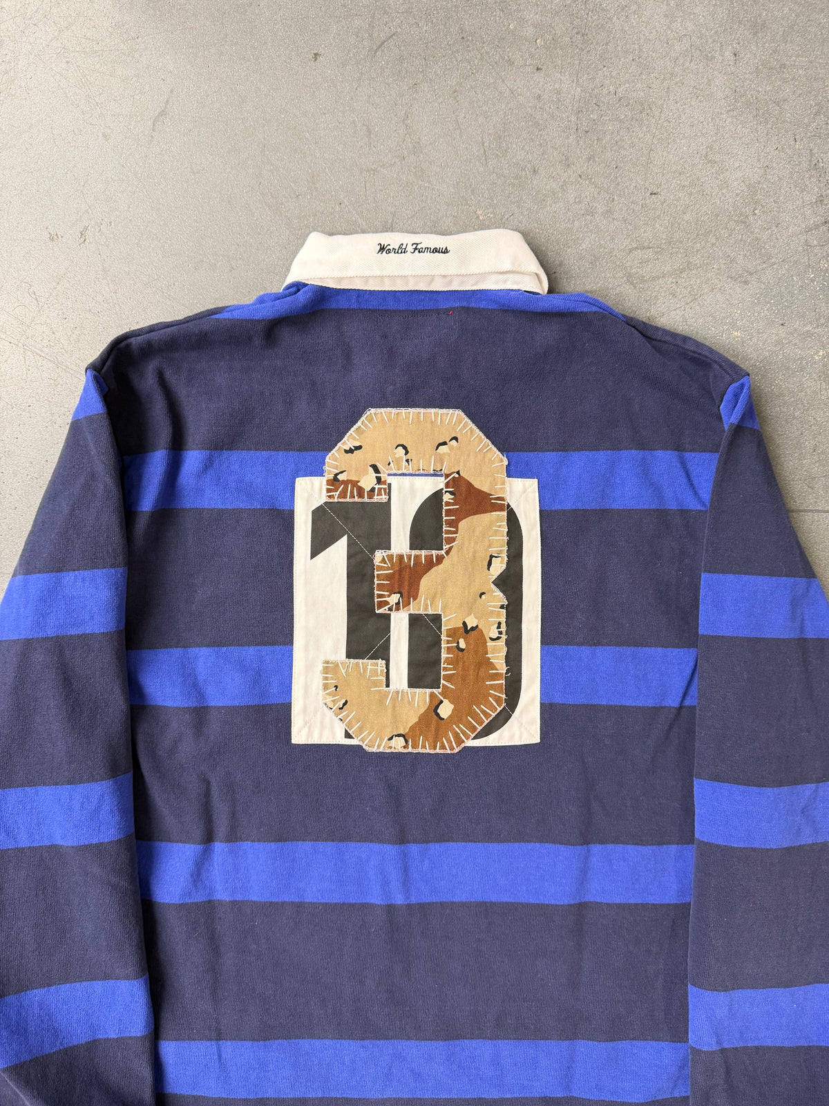 FW25 SUPREME STRIPE RUGBY SHIRT - NAVY