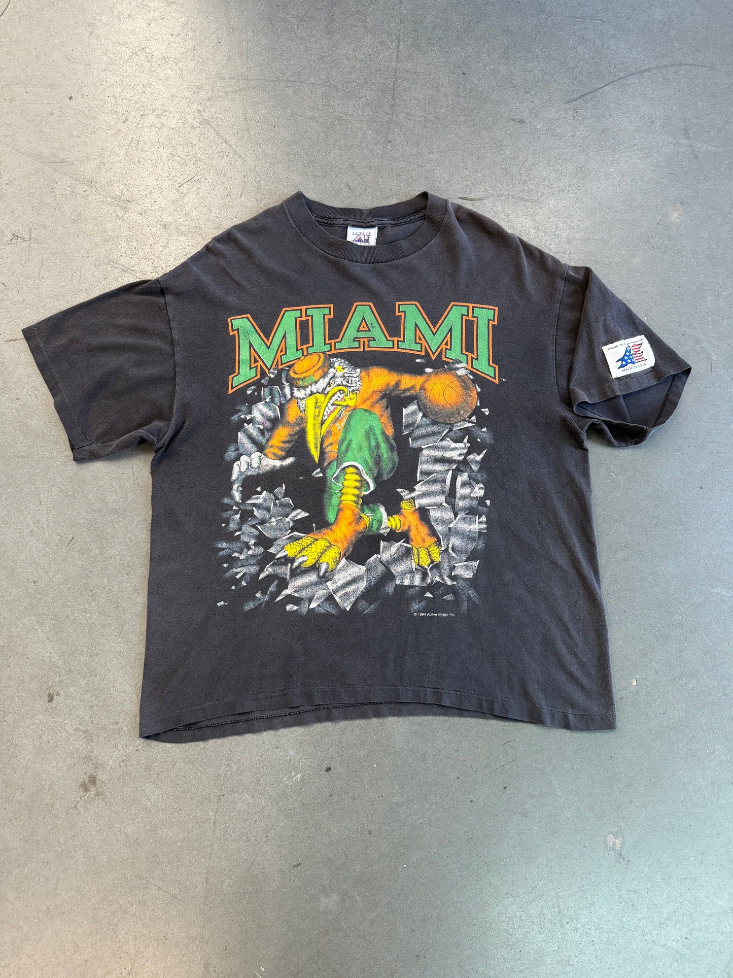 1994 MIAMI HURRICANES SEBASTIAN BASKETBALL BREAKTHROUGH SHATTERED TEE (ACTIVE IMAGE TAG)