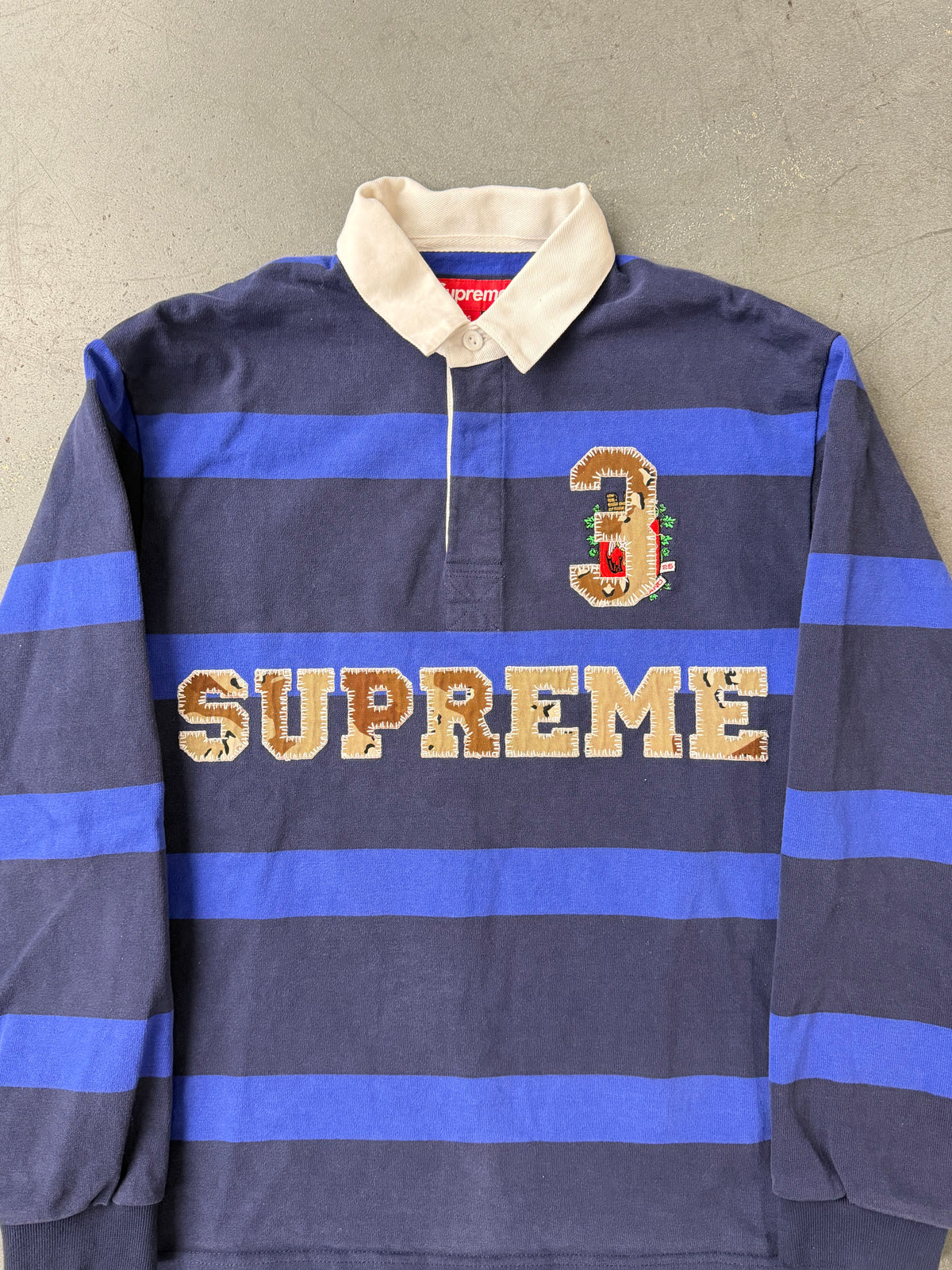 FW25 SUPREME STRIPE RUGBY SHIRT - NAVY