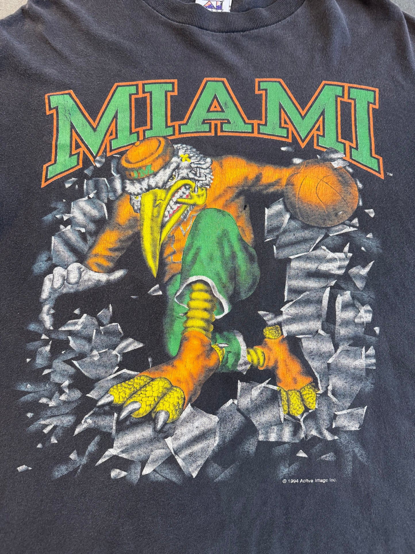 1994 MIAMI HURRICANES SEBASTIAN BASKETBALL BREAKTHROUGH SHATTERED TEE (ACTIVE IMAGE TAG)