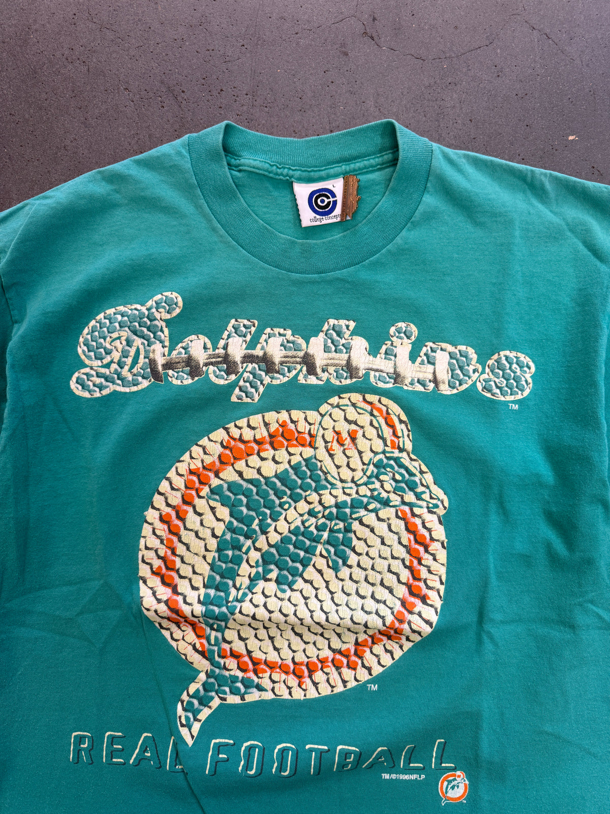 1996 MIAMI DOLPHINS FOOTBALL TEXTURE AND LACE PRINT LOGO "REAL FOOTBALL" TEE (COLLEGE CONCEPTS TAG)