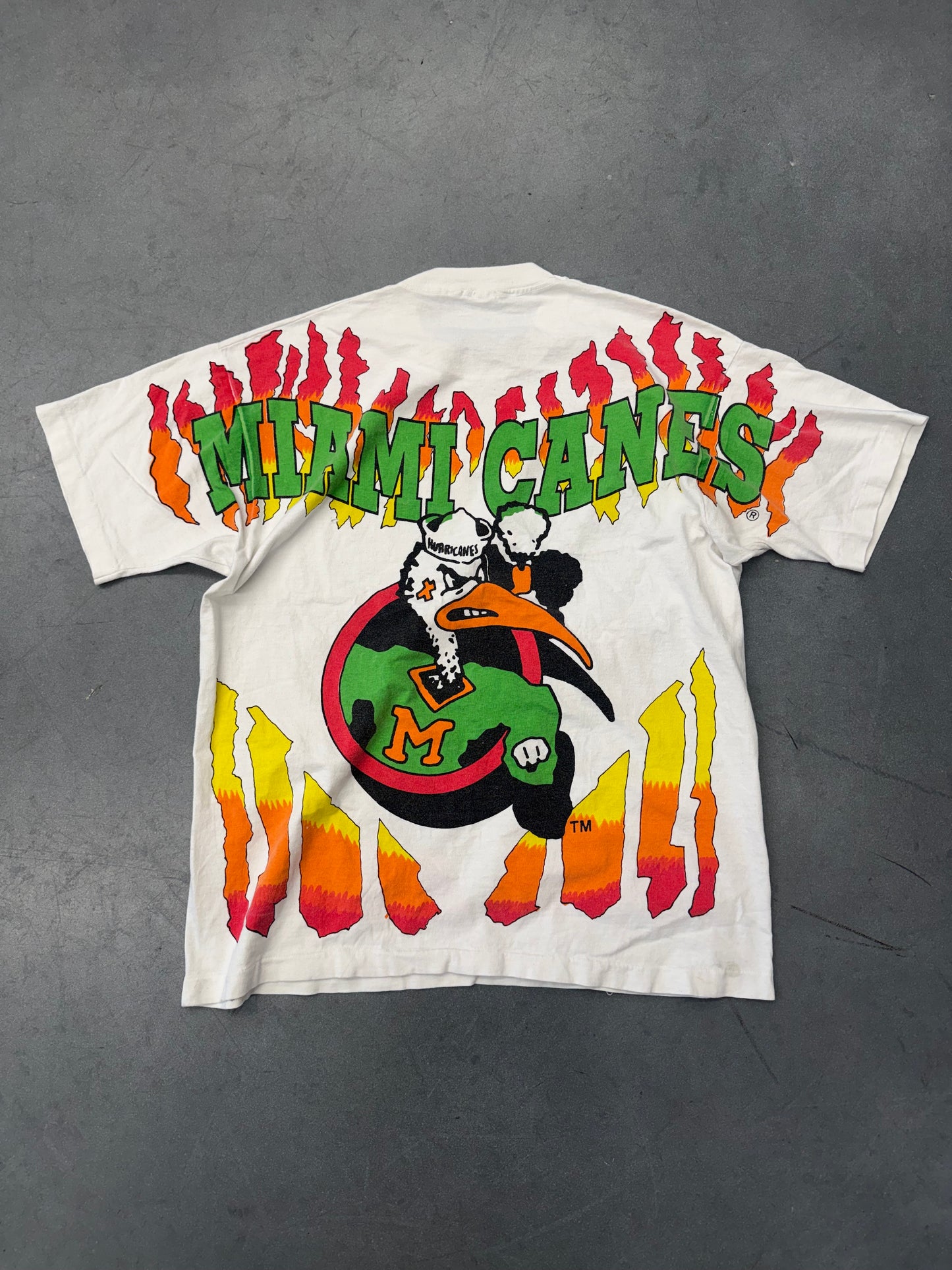 90S UNIVERSITY OF MIAMI SEBASTIAN CIRCLE LOGO FLAMES AOP TEE (FOTL TAG)