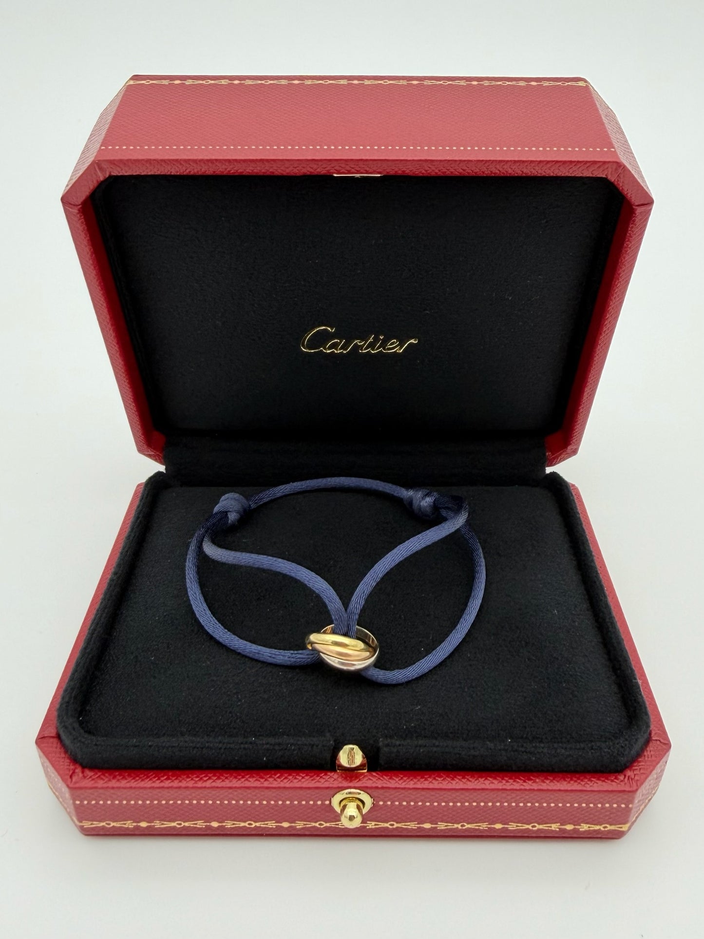 CARTIER 18K TRINITY BRACELET (WITH CASE AND COA) (ON NAVY STRING COMES WITH GREY REPLACEMENT)